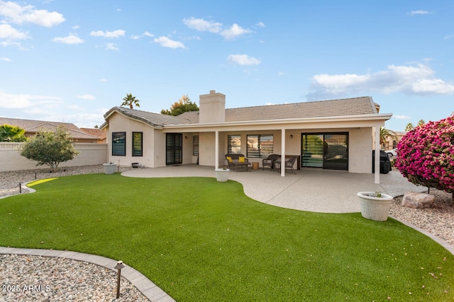 rear view of property featuring a lawn and a patio