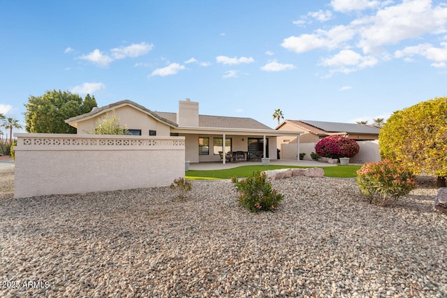 rear view of property featuring a patio area