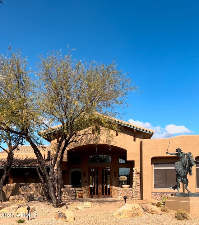 exterior space featuring french doors and stucco siding