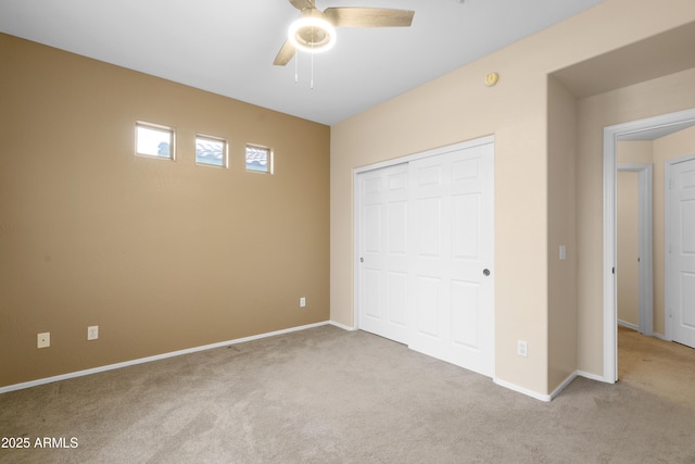 unfurnished bedroom featuring a ceiling fan, a closet, carpet flooring, and baseboards