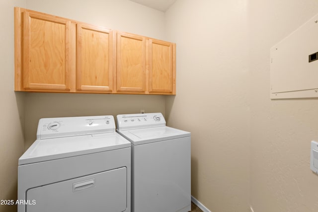 laundry area featuring electric panel, cabinet space, and independent washer and dryer