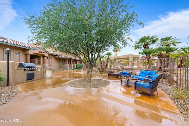 view of patio featuring exterior kitchen, outdoor lounge area, fence, and area for grilling