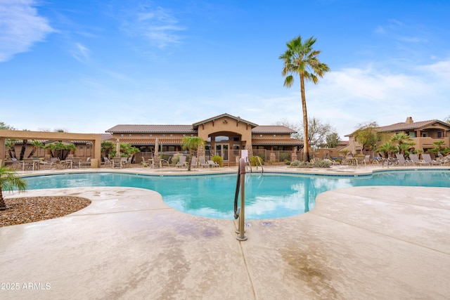 community pool featuring a patio area and fence