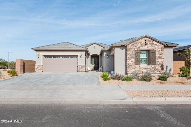 view of front of property with a garage and solar panels