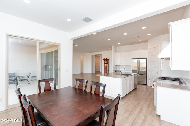 dining area featuring sink and light hardwood / wood-style flooring