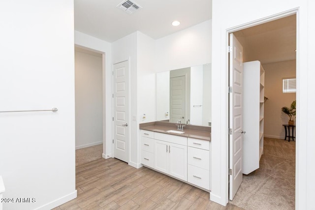 bathroom with vanity and wood-type flooring