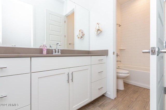 full bathroom with toilet, vanity, and tiled shower / bath