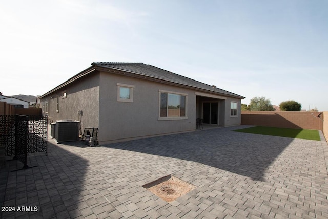 rear view of property featuring central AC and a patio