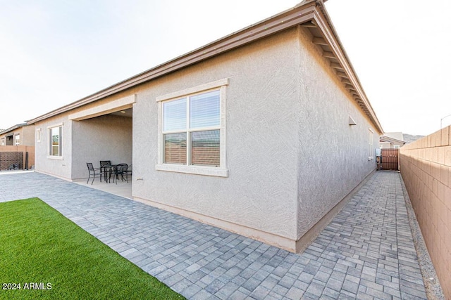 back of property with a patio