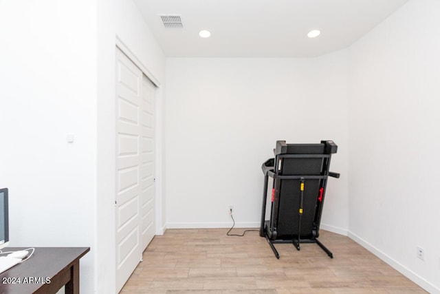 workout room featuring light hardwood / wood-style flooring