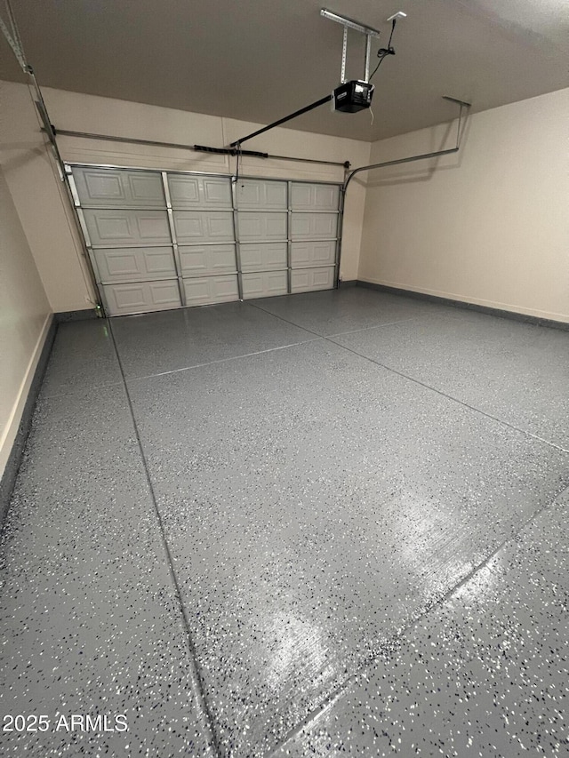 garage featuring baseboards and a garage door opener