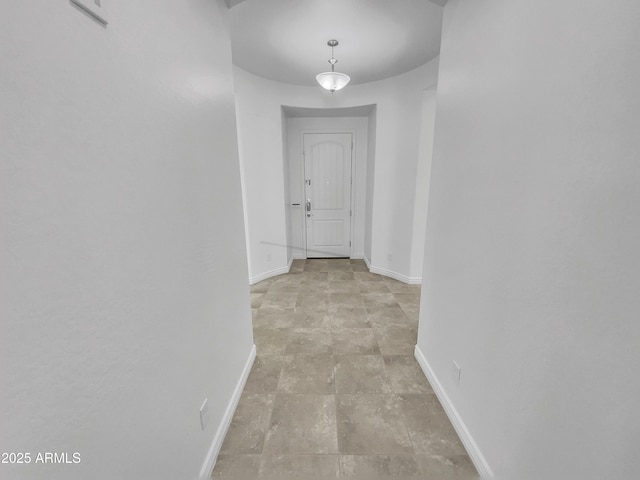 hallway featuring baseboards