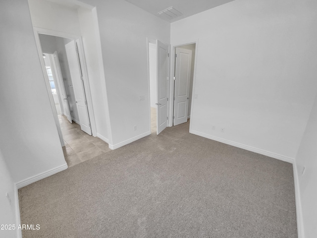 empty room with visible vents, baseboards, and carpet floors