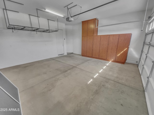 garage with baseboards and a garage door opener