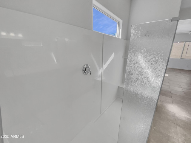 bathroom with a wealth of natural light and tile patterned floors