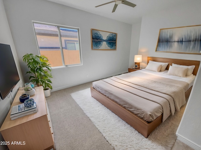 carpeted bedroom featuring baseboards and ceiling fan