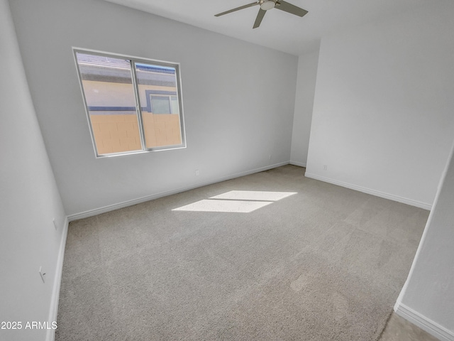 empty room with baseboards, carpet, and ceiling fan