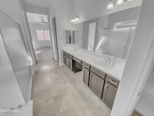 full bathroom featuring tile patterned floors, a walk in shower, double vanity, and a sink