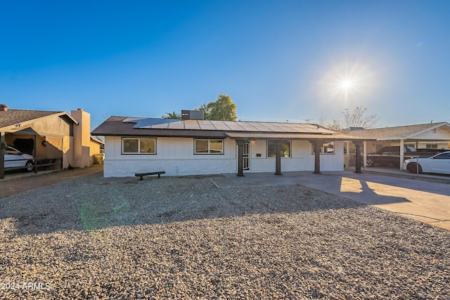 ranch-style house with solar panels