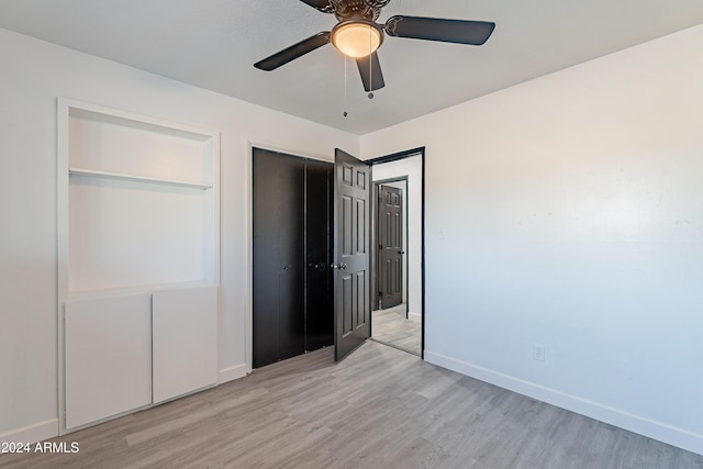 unfurnished bedroom with ceiling fan and light hardwood / wood-style floors