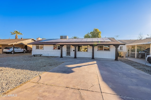 ranch-style home featuring solar panels