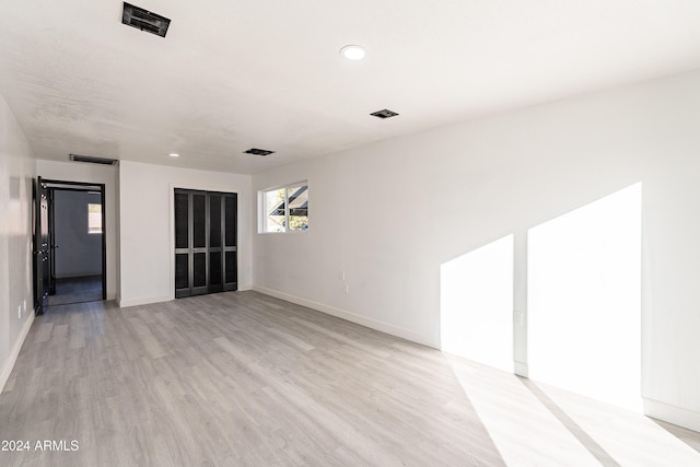 unfurnished room with light hardwood / wood-style flooring