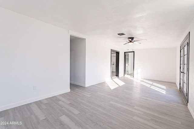 unfurnished room with light hardwood / wood-style flooring and ceiling fan