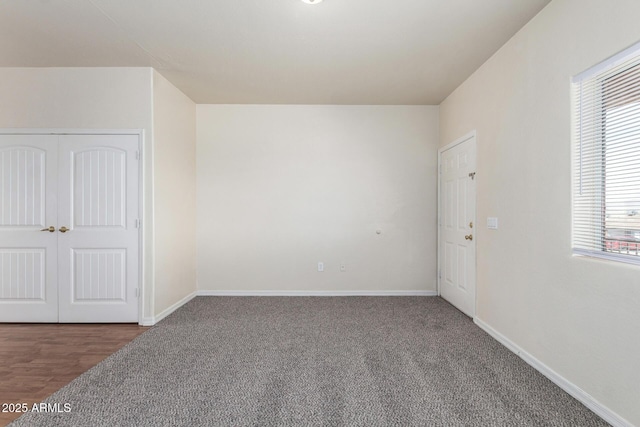 empty room with carpet and baseboards