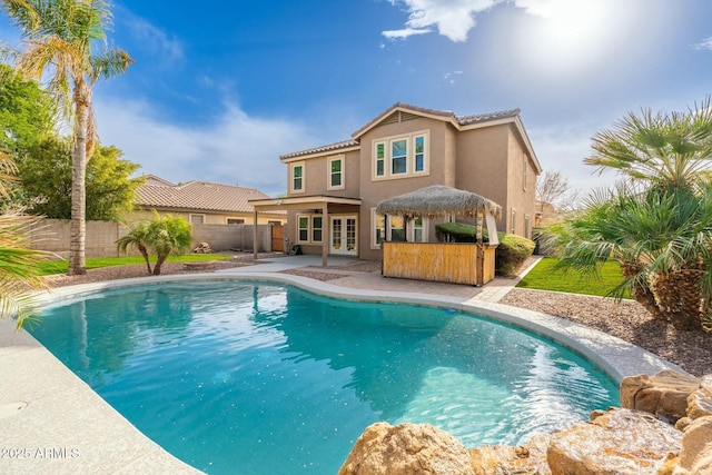 view of swimming pool with french doors