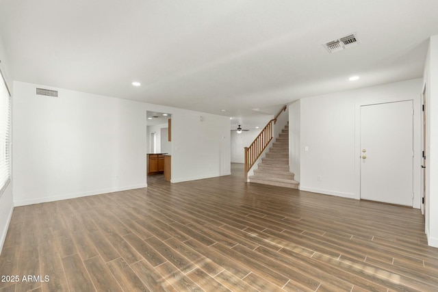 unfurnished living room featuring dark hardwood / wood-style flooring and ceiling fan