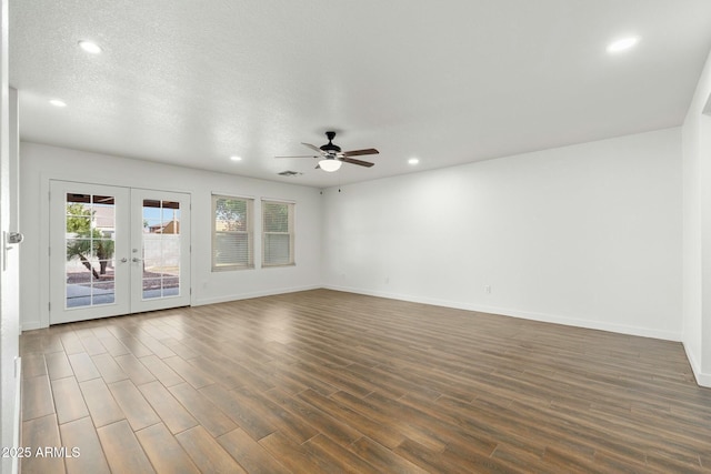 unfurnished room featuring dark hardwood / wood-style flooring, ceiling fan, french doors, and a textured ceiling