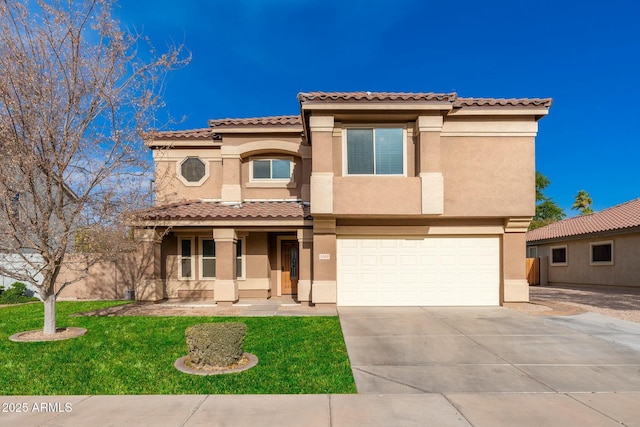 mediterranean / spanish-style home with a front yard and a garage