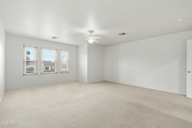 empty room with light colored carpet and ceiling fan