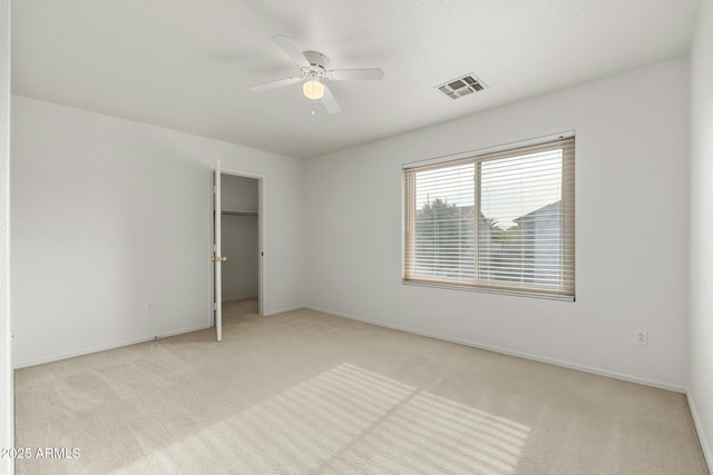 unfurnished bedroom with light colored carpet and ceiling fan