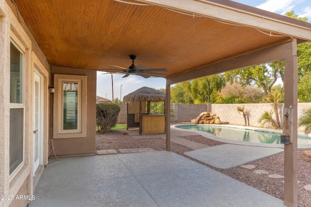 view of patio / terrace with a gazebo, a fenced in pool, and ceiling fan