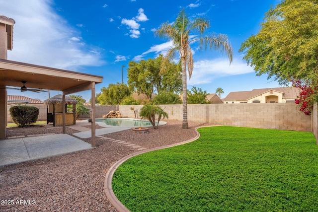 view of yard featuring a gazebo, ceiling fan, a patio area, and a fenced in pool