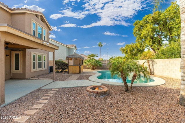 view of swimming pool featuring an outdoor fire pit and a patio area