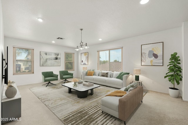 carpeted living room with a textured ceiling and a notable chandelier