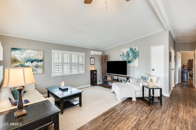 living area featuring lofted ceiling, ornamental molding, a wall unit AC, and wood finished floors