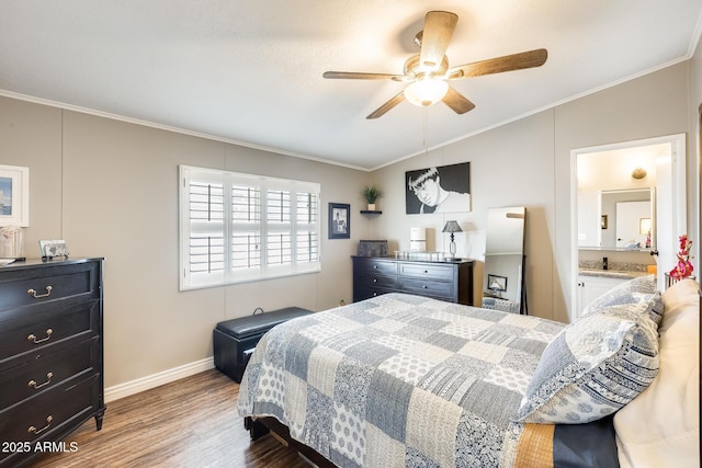 bedroom featuring crown molding, lofted ceiling, a ceiling fan, wood finished floors, and baseboards