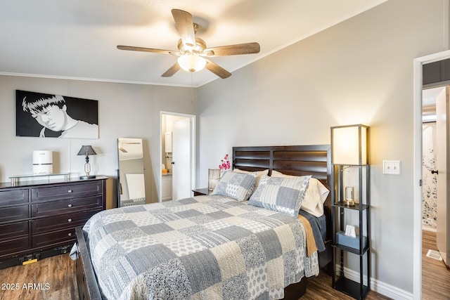 bedroom with dark wood-style flooring, crown molding, and baseboards