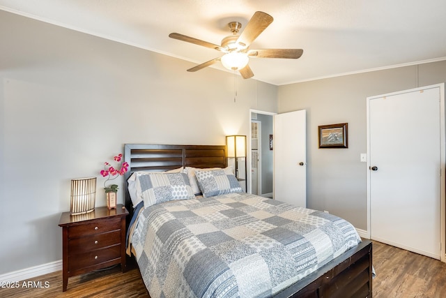 bedroom with ornamental molding, wood finished floors, a ceiling fan, and baseboards