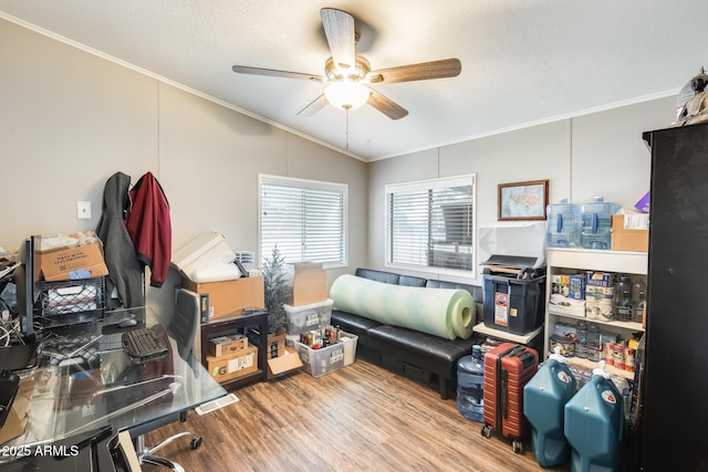 bedroom featuring a textured ceiling, wood finished floors, a ceiling fan, vaulted ceiling, and crown molding