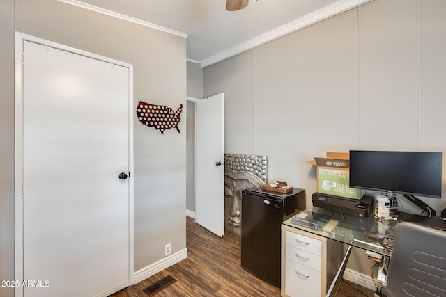 office area with ornamental molding, dark wood finished floors, visible vents, and baseboards