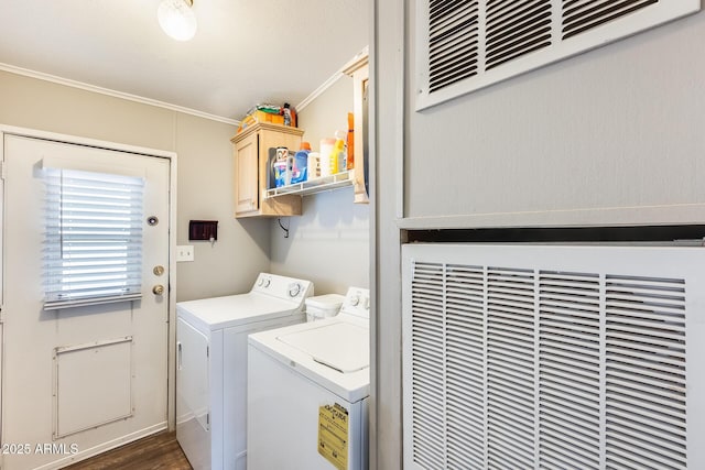 laundry room with ornamental molding, washer and dryer, and cabinet space