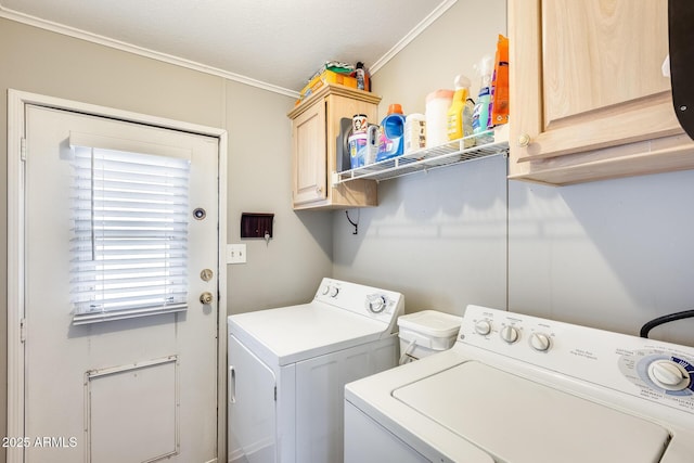 laundry room with washing machine and clothes dryer and cabinet space