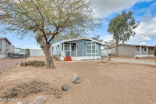 manufactured / mobile home featuring fence and driveway