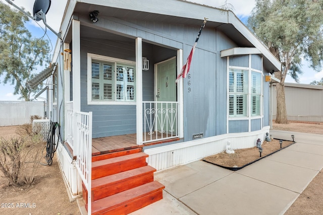 exterior space with covered porch and fence