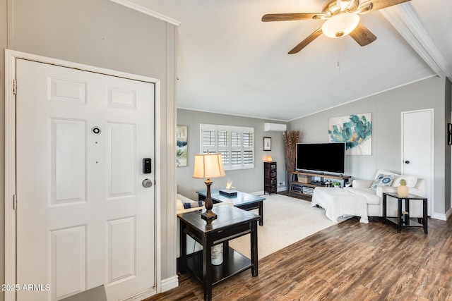 foyer with lofted ceiling, crown molding, and wood finished floors