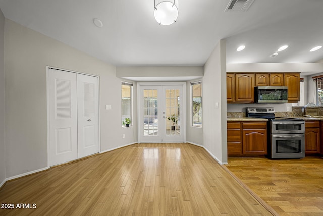 kitchen featuring light wood-type flooring, appliances with stainless steel finishes, and french doors